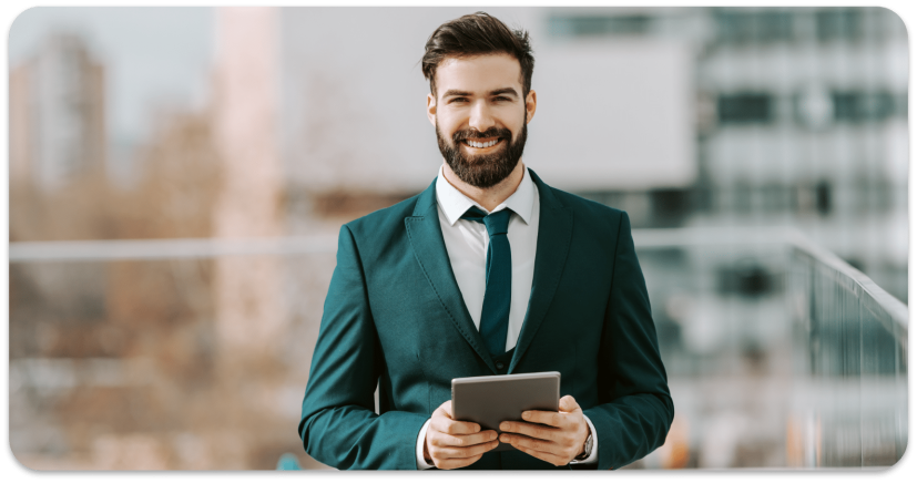 smiling-businessman-formal-wear-using-tablet-while-standing-rooftop